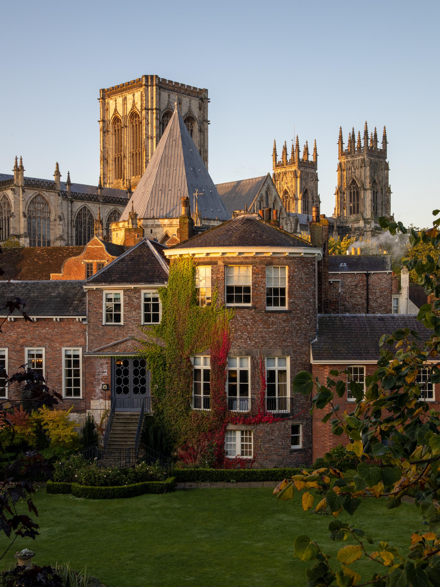 Autumnal early morning light catches York Minster and Grays Court Hotel from a vantage point on the city walls