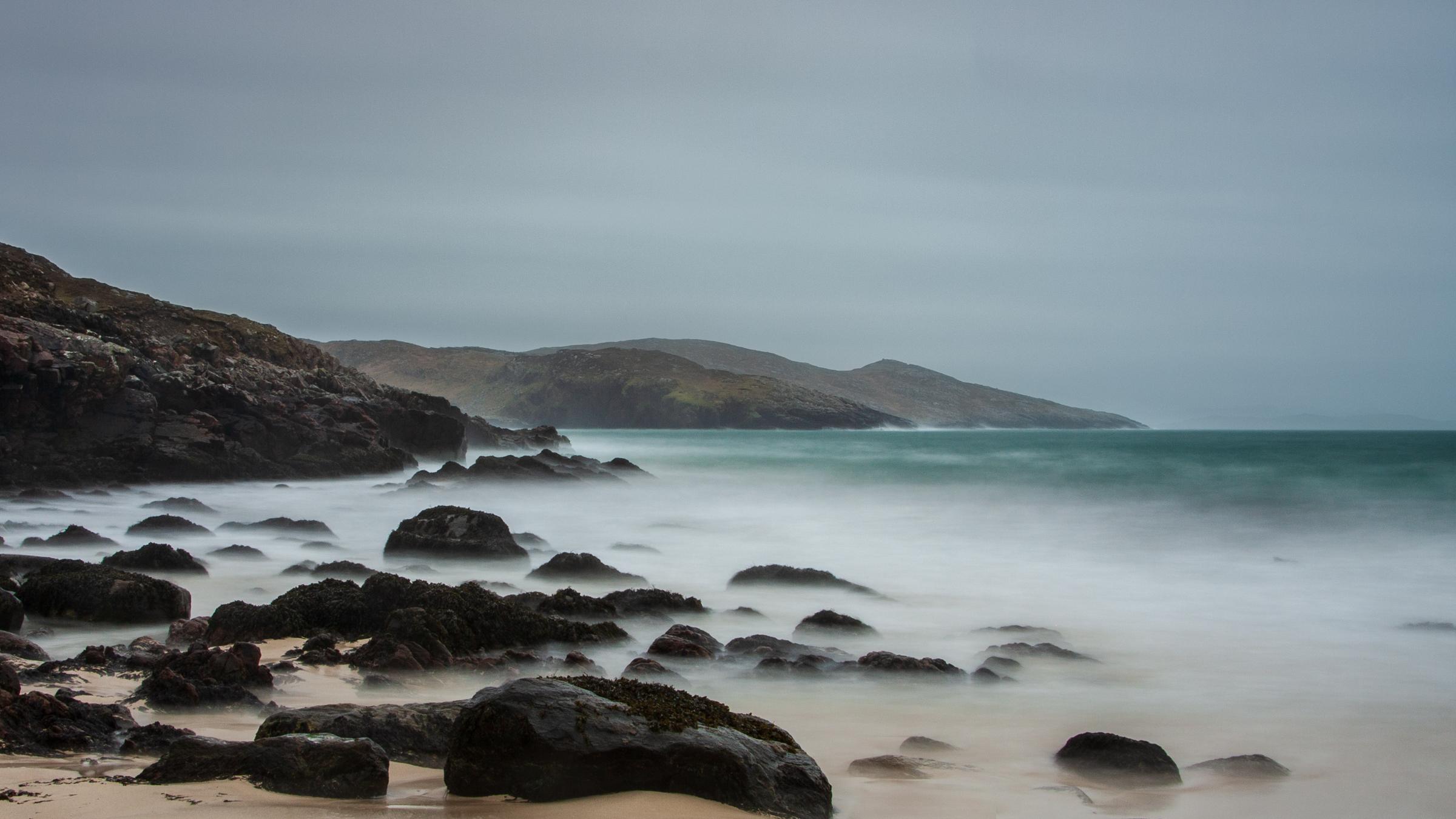 Hushinish is a remote place along a long road along the coast line of North Harris. On this occasion, as in many, the waves were whipped up by the strong winds and throwing themselves onto the rocks.  Beautiful iconic colours of dark rocks, golden sand and sea greens.