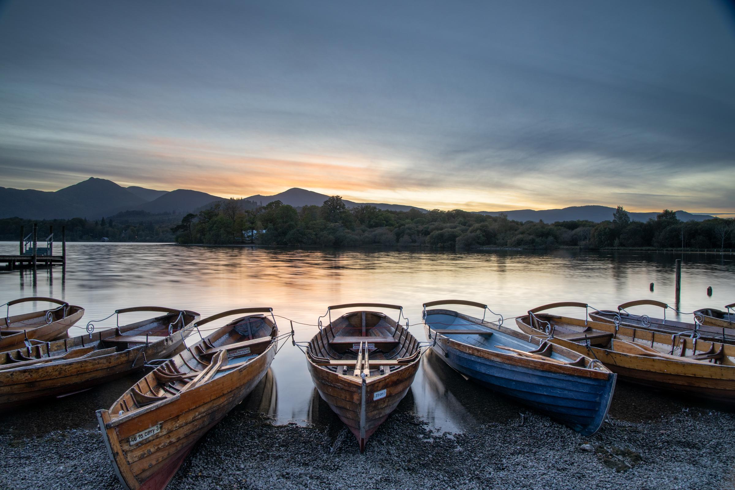 Row boats at Keswick Launch at sunset⁠