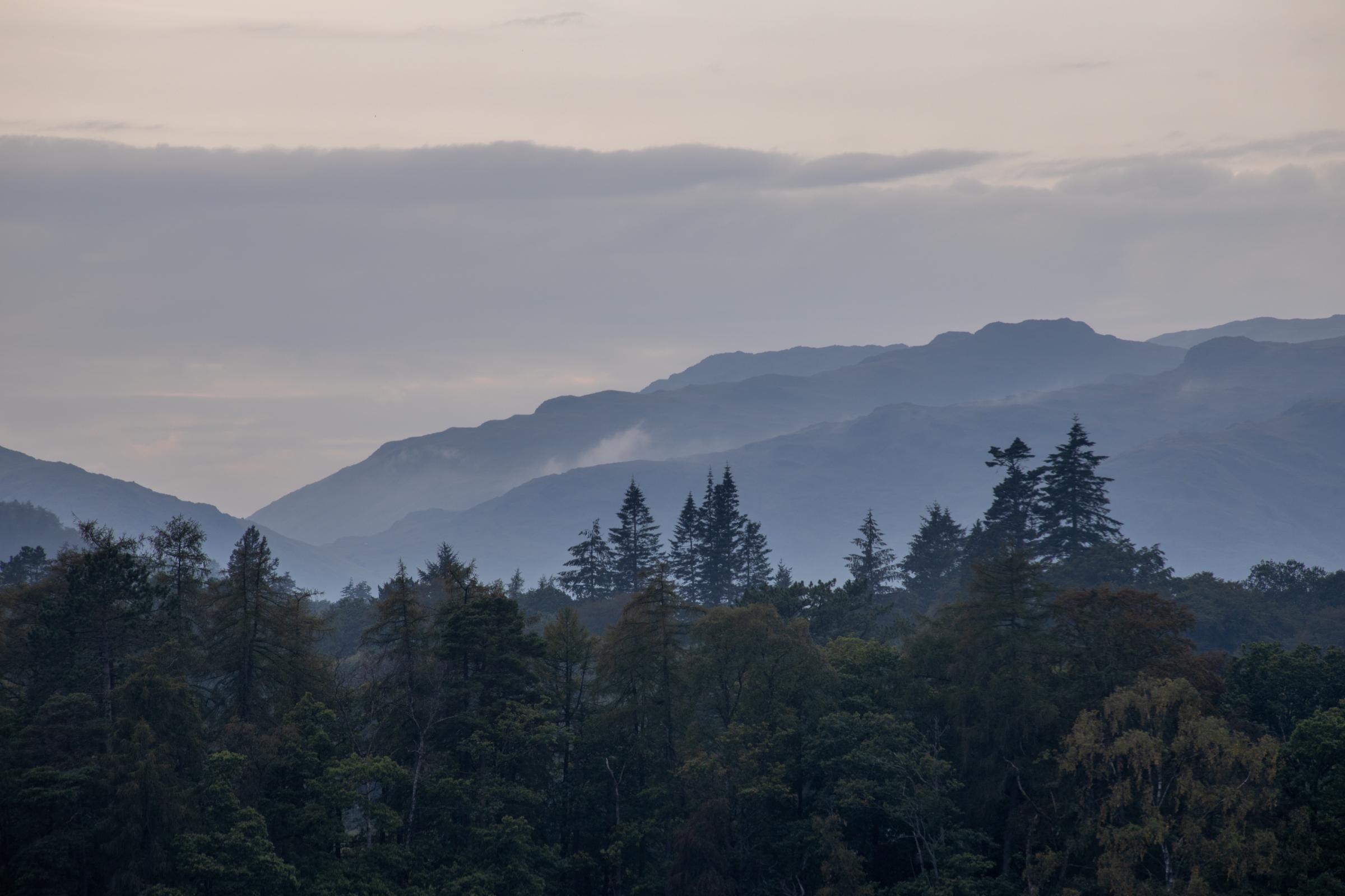 Taken from YHA Ambleside at Lakehead, after a glorious summers day, clouds rolled in and mist started to form on the fells accentuating the layers of trees, ridges and clouds.