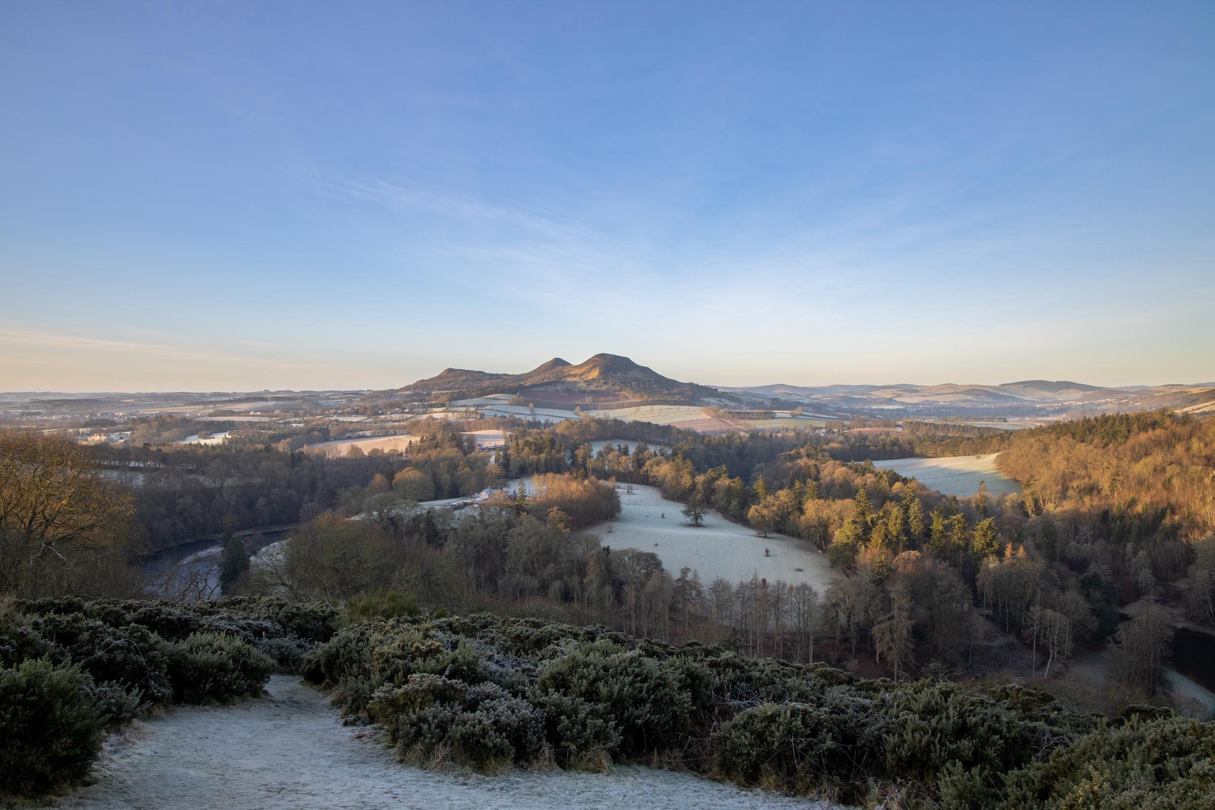 A frosty sunrise of the Eildon Hills looking over the bend in the river tweed around Old Melrose from Scott's View.