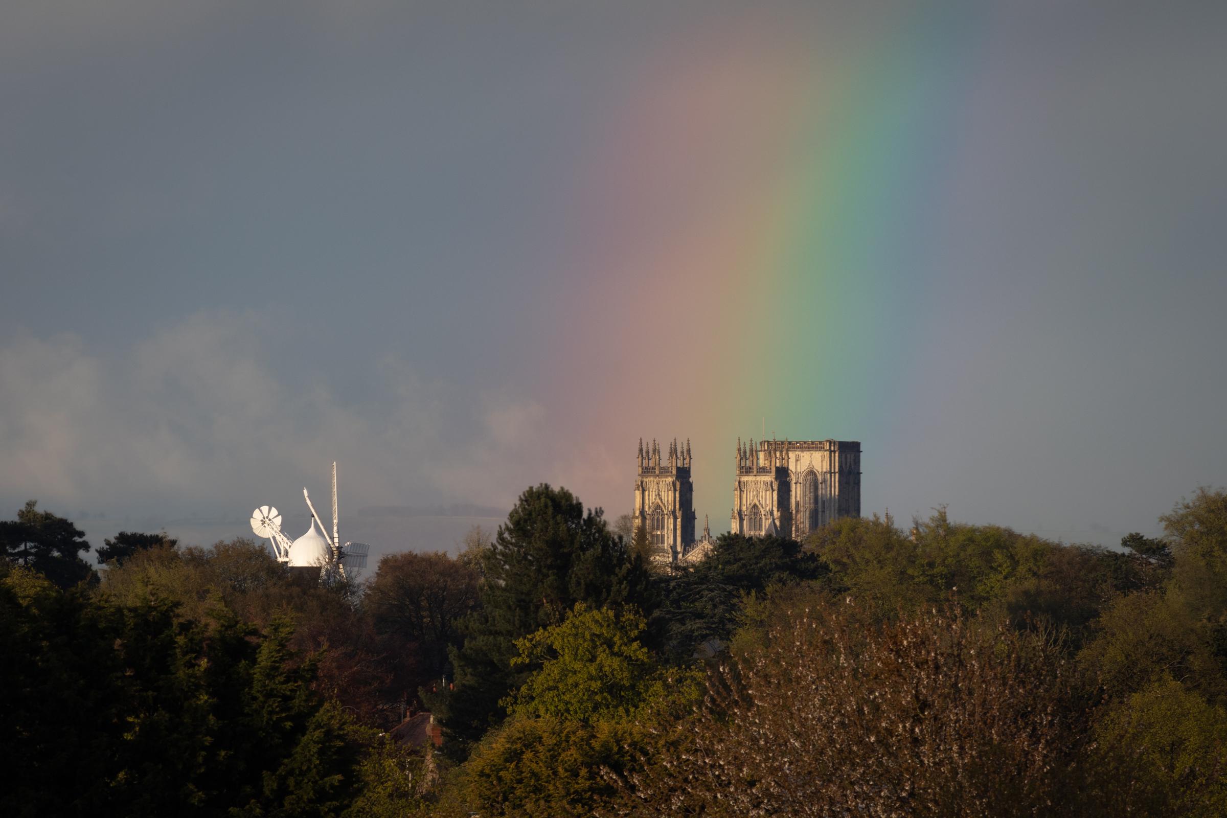 After a day of stormy wet weather the clouds broken about an hour before sunset and I noticed a rainbow.  I had a hunch that the direction of the sun was around 40 degrees off the line of sight from this location, so I rushed there just in time and it was perfectly aligned with Holgate Windmill and York Minster.  A truly special moment.
